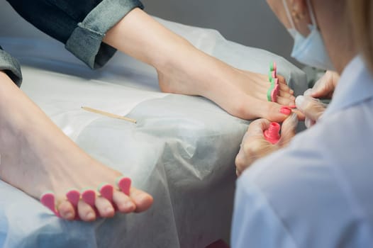 A professional technician grinding machine, nail polish, professional nail care the hands and feet