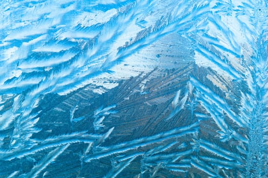 Beautiful frosty glass frostwork and ice flowers on window glass