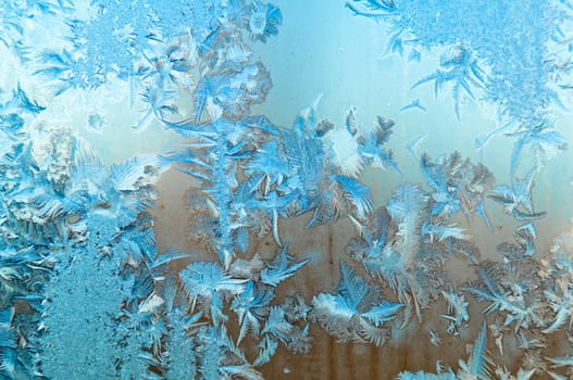 Beautiful frosty glass frostwork and ice flowers on window glass