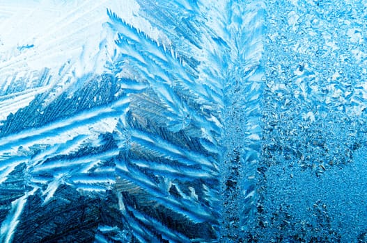 Beautiful frosty glass frostwork and ice flowers on window glass