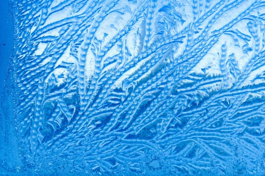 Beautiful frosty glass frostwork and ice flowers on window glass