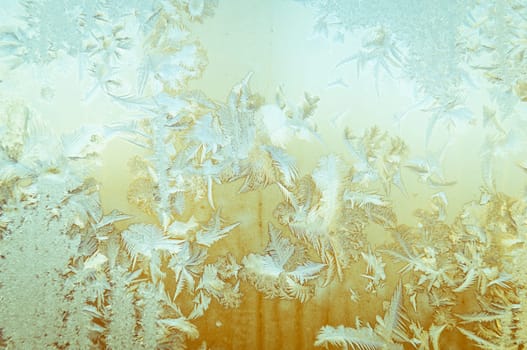 Beautiful frosty glass frostwork and ice flowers on window glass