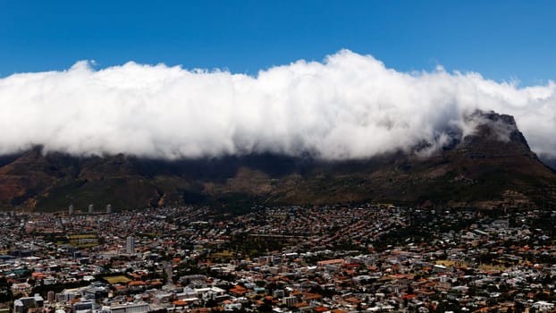Table Mountain is a flat-topped mountain forming a prominent landmark overlooking the city of Cape Town in South Africa. It is a significant tourist attraction, with many visitors using the cableway or hiking to the top