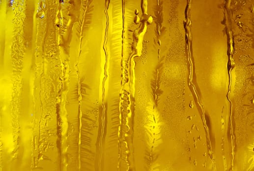 Melted and frosted ice pattern on frosty window glass in winter