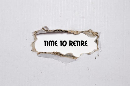 The word time to retire appearing behind torn paper