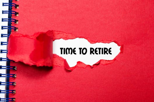 The word time to retire appearing behind torn paper
