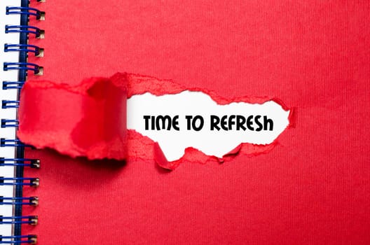 The word time to refresh appearing behind torn paper