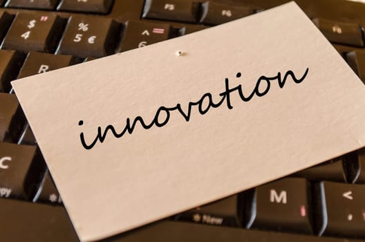 Innovation text concept over keyboard background