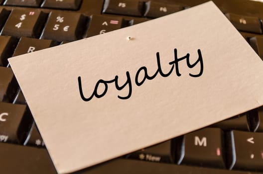 Loyalty text concept over keyboard background