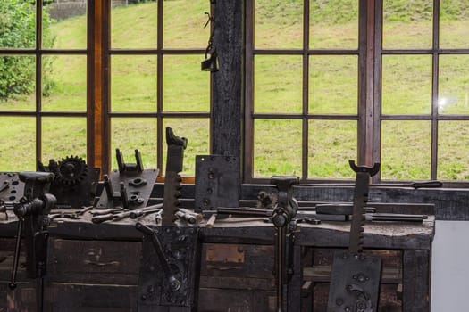 Old workshop equipment with various tools and machines..