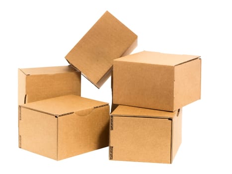 Five irregularly stacked small brown cardboard boxes insulated on white.