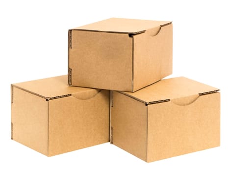 Three irregularly stacked small brown cardboard boxes insulated on white.
