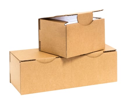 Three irregularly stacked small brown cardboard boxes insulated on white. Top box opened and illuminated inside