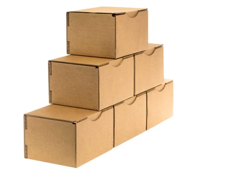 Six stacked small brown cardboard boxes insulated on white.