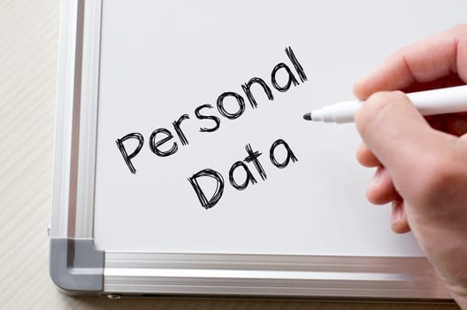 Human hand writing personal data on whiteboard