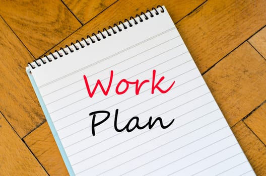 Human hand over wooden background and work plan text concept