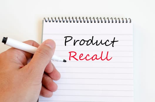 Human hand over wooden background and product recall text concept
