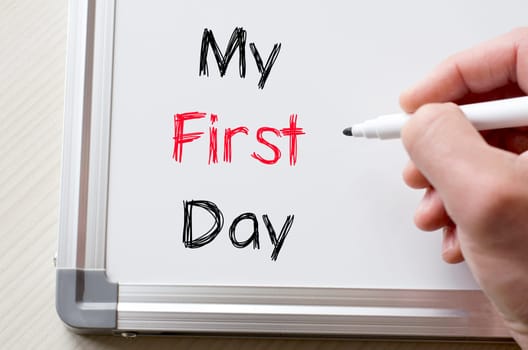 Human hand writing my first day on whiteboard