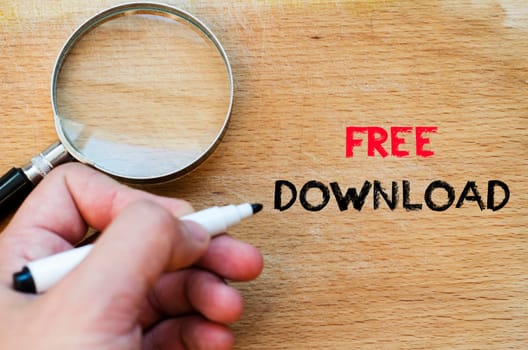 Human hand over wooden background and free download text concept
