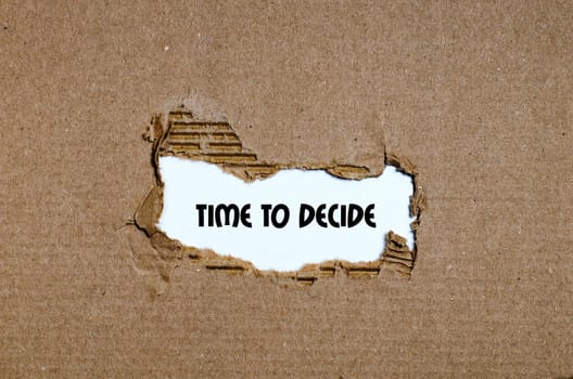 The word time to decide appearing behind torn paper