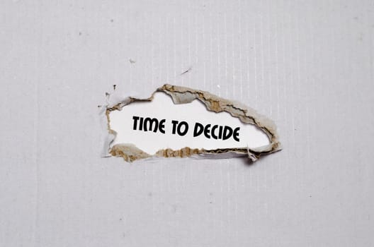 The word time to decide appearing behind torn paper