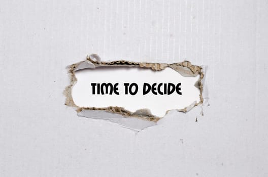 The word time to decide appearing behind torn paper