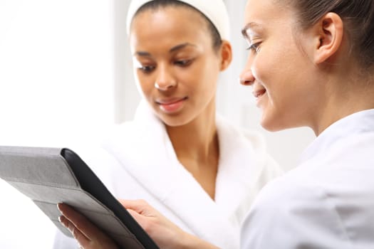 beauty advice,woman in beauty salon. cosmetic consultancy,direct sales. beauty portal,advice in the office beautician advises clients of the appropriate cosmetic skin type