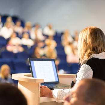 Female speaker at Business Conference and Presentation. Audience at the conference hall. Business and Entrepreneurship. Business woman. Horizontal composition.