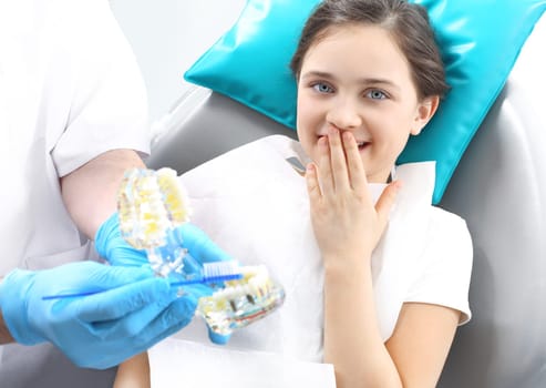 a child in a dental chair during a dental treatment. overview of oral hygiene. treatment of tooth loss,a child at the dentist. dentist,fear of the dentist. a dental office,a child in a dental chair