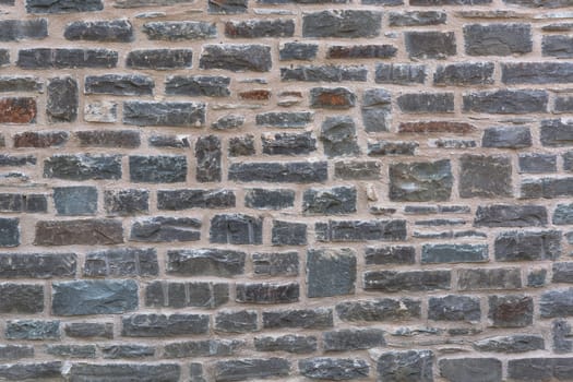 Background,old quarry stone wall with relief texture and shadows.