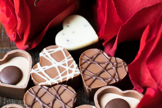 Heart shaped chocolates and red roses.