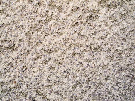 Format-filling view of a rough concrete surface with small pebbles
