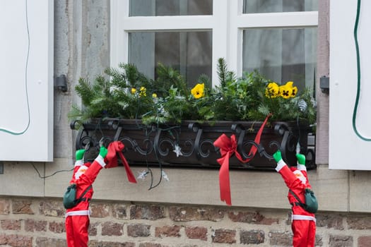Christmas decoration with fir branches of a windowsill in the outdoor area..