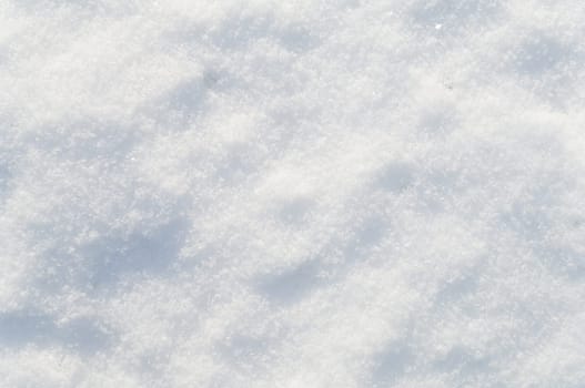 Winter snow background white snow flakes and crystals in natural light