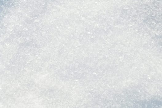 Winter snow background white snow flakes and crystals in natural light