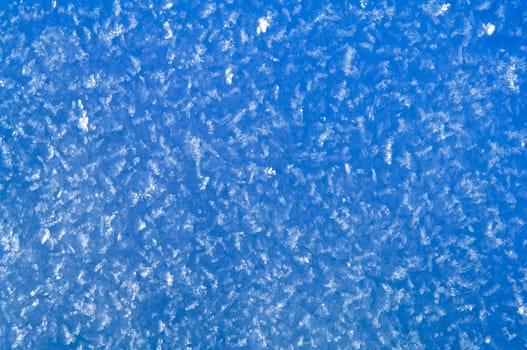 Blue snow and hoarfrost background with big transparent crystals