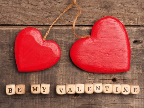 Wooden dices with heart shape on a rustic wooden background, love concept image