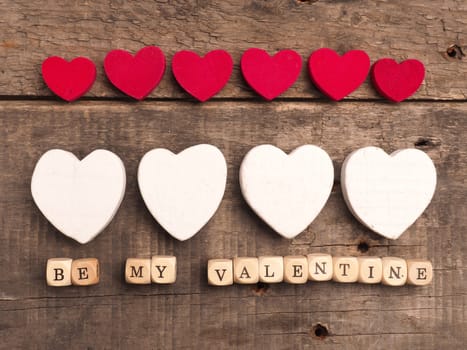 Wooden dices with heart shape on a rustic wooden background, love concept image