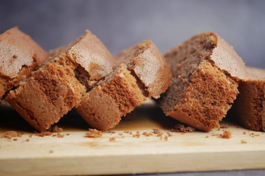 Slices of soft brown bread are arranged on a wooden board.