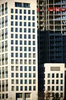 Various nested high-rise facades of old and new building complexes as well as shell buildings.