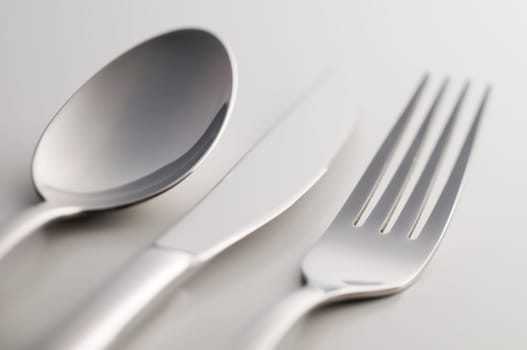 Silverware: fork, knife and spoon on white background