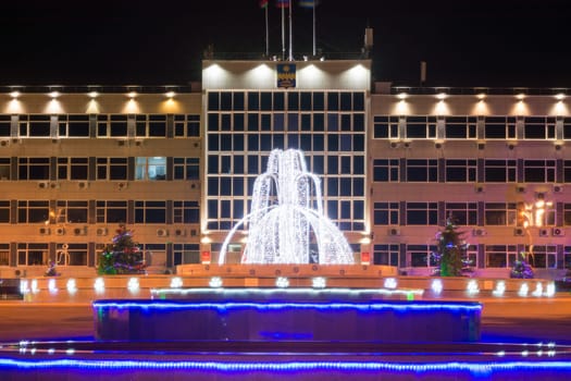 Anapa, Russia - January 7, 2017: Night landscape with a view of the administration of the city of Anapa resort and the fountain in front of it in the New Year holidays