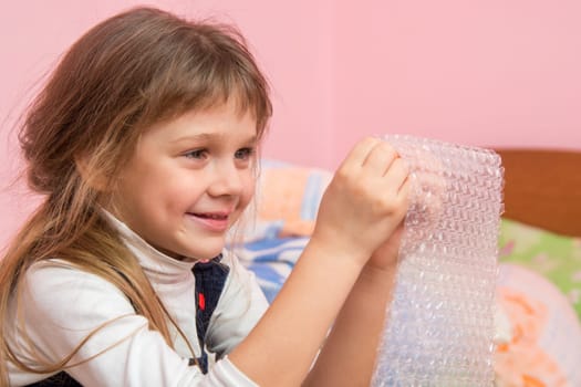 Girl eats balls on the wrapping paper