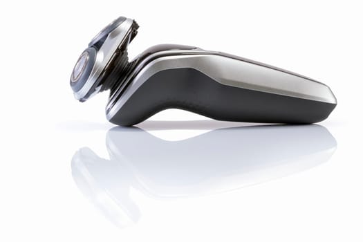 Electric shaver closeup on white background. Multi Precision text written on razor head! Best precision for shave!