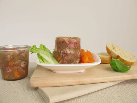 Homemade Sülze with salad and rolls