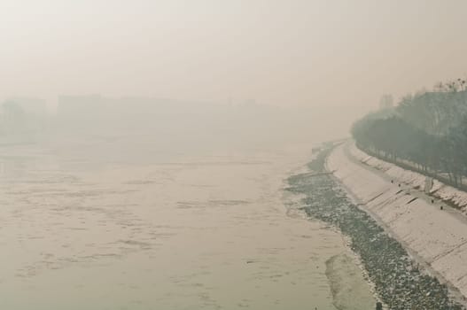 Cold weather, anticyclone favours air pollutants to accumulate and form a dense layer named smog over the city