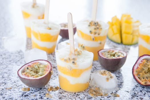 Homemade popsicles with passion fruit and mango