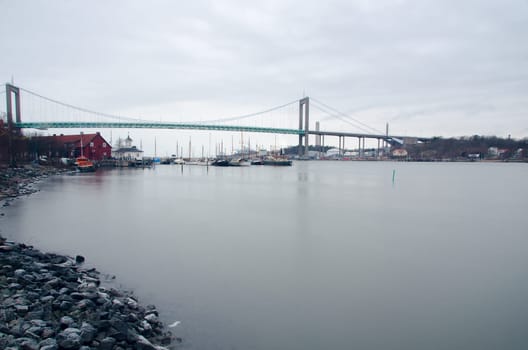 one big bridge over the water in gothenburgs harbour and some boat on the pier