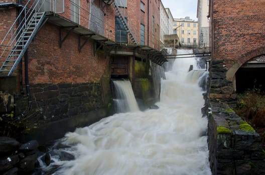 Rushing water free falling down in the side of the house