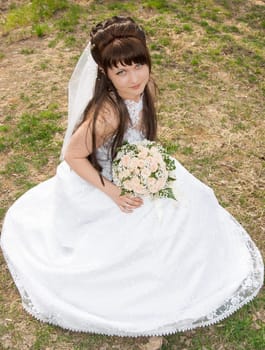 Portrait of the bride with a bunch of flowers, in a wedding dress